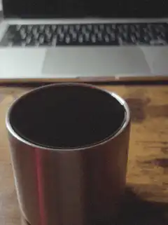 steaming metal cup on desk