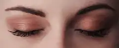 Eyes opening to reveal red irises