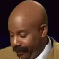 Steve Harvey looking down and nodding