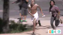 Man in towel running from woman