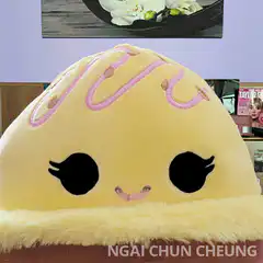 Woman peeking through donut plushie