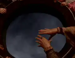 Hands hovering over a swirling blue pool