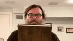 Man reading book that glows