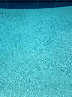 Blue swimming pool water ripples