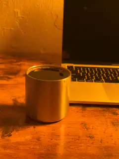 coffee cup next to laptop