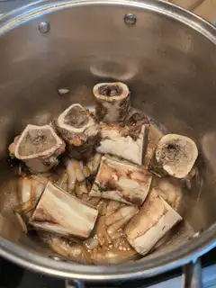 Roasting beef bones in a pot