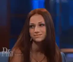 Woman fixes hair on Dr. Phil