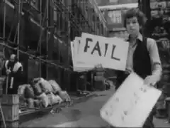 Man holding a sign that says FAIL