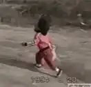 Toddler running with a cat