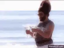 Bearded woman in bikini holding a martini