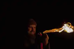 Man blows fire from lighter