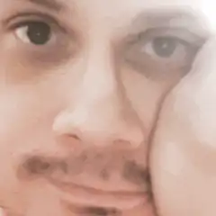 Man resting face on hand