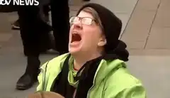 Man in green jacket screaming