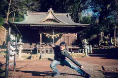 Man posing in front of Japanese shrine