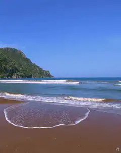 waves rolling onto a sandy beach