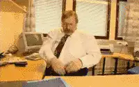 Man throws papers off desk