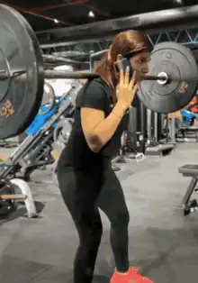 woman doing squats while talking on phone