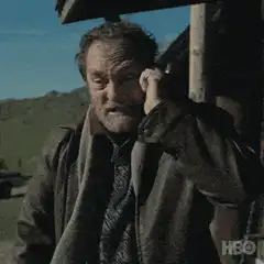 Man on phone looks at phone