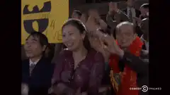 Asian woman clapping enthusiastically