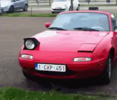 Red Mazda Miata pop-up headlights