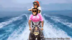 Two people riding a jet ski
