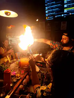 Bartender flaming cocktail at bar