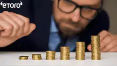 Man stacking coins with #STACKINGSATS