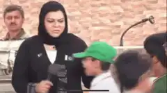 Woman slaps boy with green hat