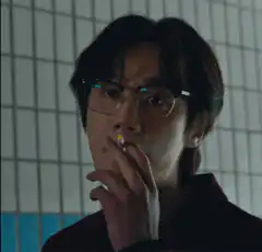 Man removes glasses while smoking