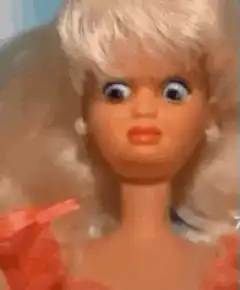 Barbie doll with googly eyes