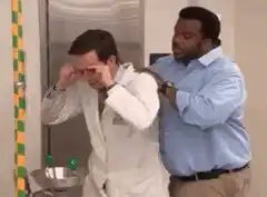 Man drinks from water fountain while being pushed