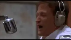 Robin Williams singing into microphone