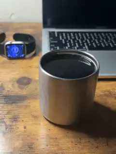 Coffee cup on desk with laptop