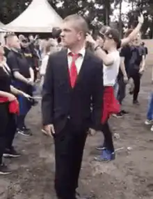 Man in suit dancing at festival