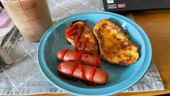 Breakfast plate with sausages, toast, and ketchup