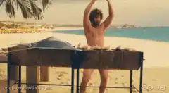 Bearded man dancing at beach grill