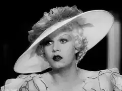 Jean Harlow adjusting her hat