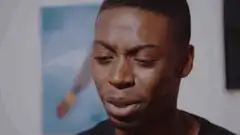 Man reacts with disgust then joy to laptop