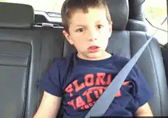 Boy in car seat making funny face