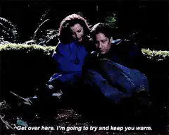 Mulder and Scully cuddling in the woods