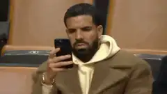 Drake looking at phone disapprovingly