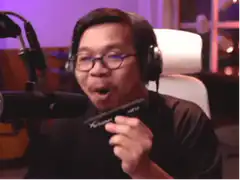 Man playing harmonica and laughing
