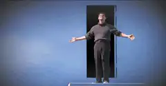 Man bowing in front of a door
