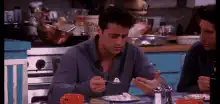 Ross eating cake with a fork