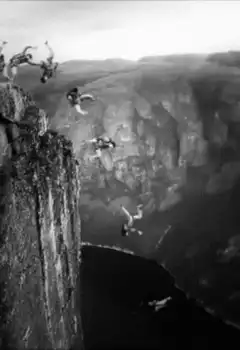 people jumping off cliff into water