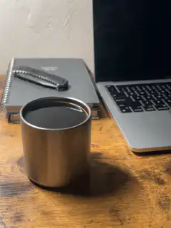coffee cup on desk with laptop