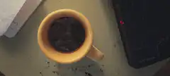 yellow mug of coffee on desk