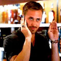 Ryan Gosling holding phone and waving