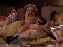 Fat man eating pizza in robe