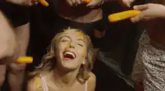 Woman laughing while getting fed carrots